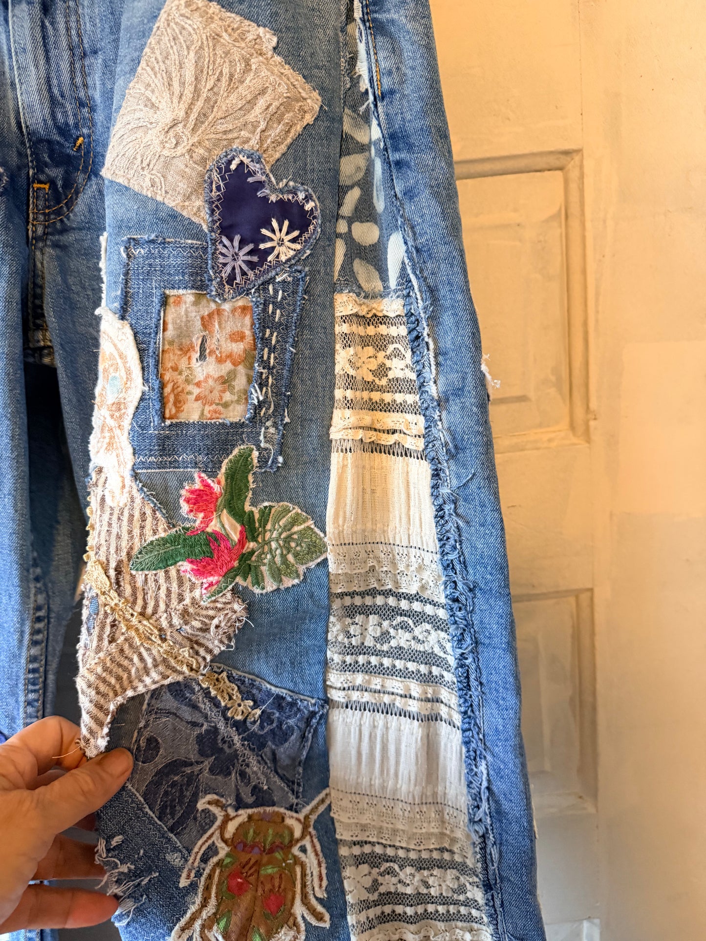 Patchwork upcycled denim jeans, boho hippie style distressed denim, front and frayed jeans