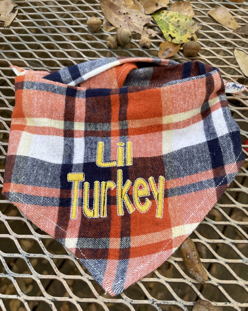 Orange and blue plaid dog bandana.  Flannel Thanksgiving dog bandana embroidered with Lil Turkey in gold lettering